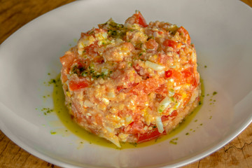 Salad with quinoa, peeled tomatoes, roasted peppers, grated egg, cheese and dressing.
