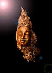 Fototapeta na wymiar Head Buddha statue made of wooden black background