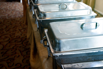 Close up stainless pot of food with cover in restaurant, Food tray and stir-fry on the table in the restaurant, Prepared tray of food in kitchen