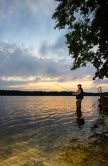 Angler catching the fish during an overcast day