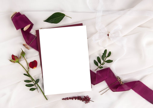 Burgundy wedding invitation mockup with rose and ribbon