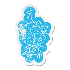 cartoon distressed sticker of a cat wearing santa hat