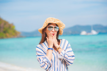 Summer time woman vacation on the beach. Relax time in summer lifestyle outdoor shot on tropical island beach.