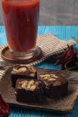 close up of brownie cake on wooden blue background