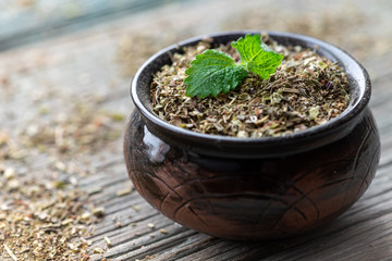Dry lemon balm in a bowl. Fragrant medicinal herbs for tea.