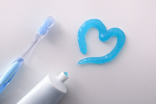 Dental health concept with toothbrush tube and toothpaste heart detail