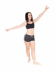Fototapeta na wymiar Dancing young woman standing hands raised in shorts