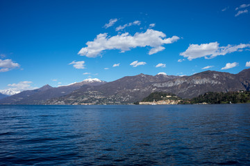 Italy, Lecco, Lake Como, a large body of water with a mountain in the background