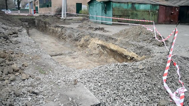 Pit dug protective red tape