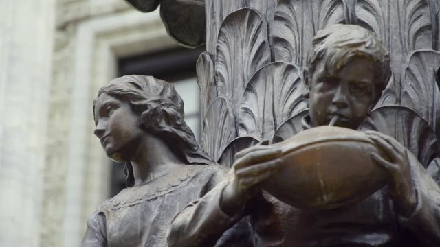 Rack Focus Shot of a Bronze Sculpture of Children