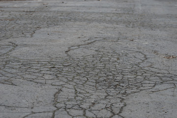 dark cracked asphalt background texture selective focus