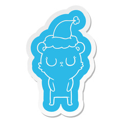 peaceful cartoon  sticker of a bear wearing santa hat