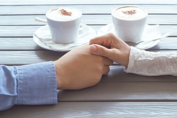 man and women hold each other hands coffee shop hands of people romance relationship