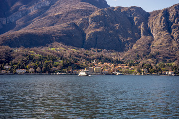 Italy, Lecco, Lake Como, a large body of water with a mountain in the background