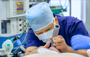 Anesthesiologist performing tracheal intubation - 253803214