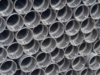 Black plastic pipes of various diameters in a row