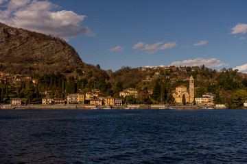 Naklejka premium Italy, Lecco, Church clock tower overlooking Lake Como
