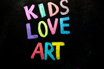 colored text kids love art on blackboard