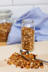 Granola in glass bottle on wooden table