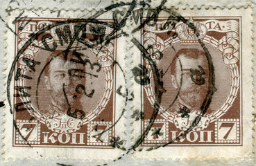 Russian empire - 5 Feb 1913: russian historical stamp: two postage stamps with a portrait of Emperor Nicholas ii, with black ink postal cancellation, 7 kopecks, Russia, Smolensk, Khmelita,