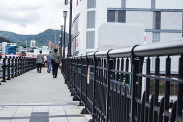 Korean pedestrians walking on bridge in Busan, Korea