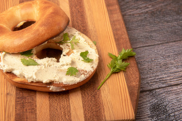 Bagel topped with cream cheese and chives, taken with copy space 