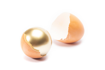 An egg cracked and have golden sphere inside on white background
