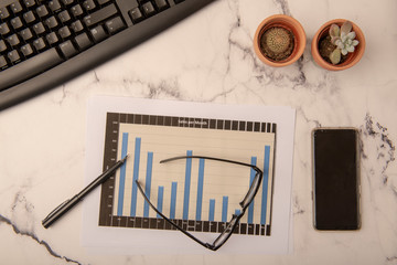 Office desk with graphs and paperwork 