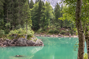 Clear turquoise colored water of Fusine Lake in Italian Alps. The lakes are in an area that is part of the Julian Alps, close to border with Slovenia.