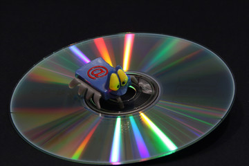 CD with color beams and electronic key on a dark background. Correction fluid,electronic key, DVD...