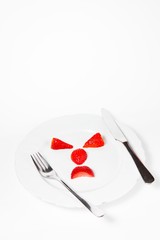 Emoticon make from strawberries saying - mind your body weight.