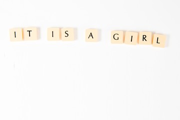 Inscription IT IS A GIRL - on white background.