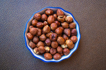 Top view of hazelnuts in porcelain bowl - Image