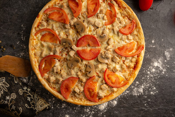 Meat pizza with pork and mushrooms