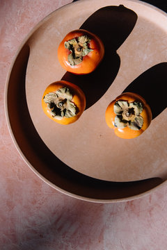 Persimmons on Terracotta