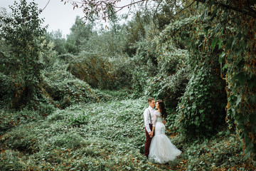 stylish bride and groom in the garden. rustic style