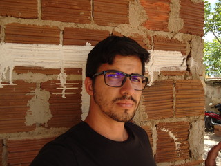Young man of Arab descent wearing glasses