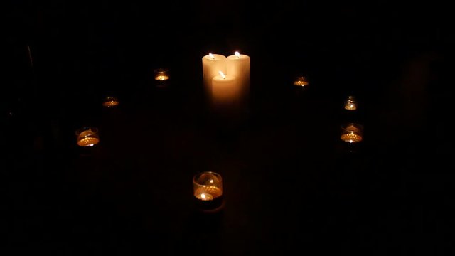 A circle of candles in the dark