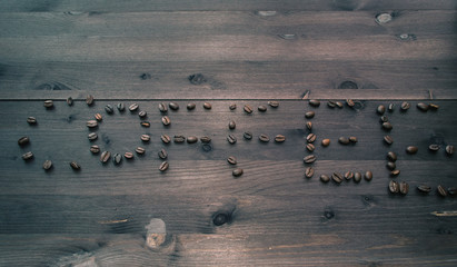 coffee text made of coffee beans on dark background