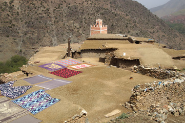 carpets drying on a roof in a berber village in Morocco
