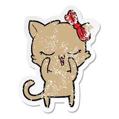 distressed sticker of a cartoon cat with bow on head