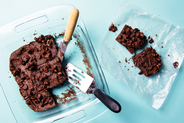 Brownies cut in pan with chocolate chips on top