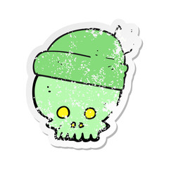 retro distressed sticker of a cartoon skull wearing hat