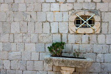 Authentic, stone wall, with beautiful, old, wooden shutters and window, minimal style, bright colors, background.