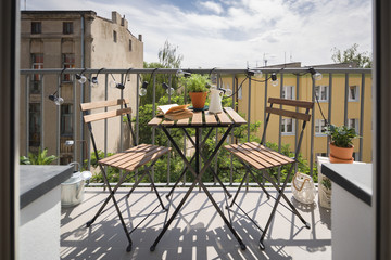 City balcony with wooden table