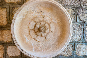 Traditional, authentic, old stone plate on a stone wall