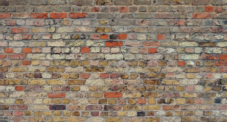 old multi colour red brick wall