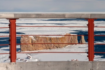 Winter view of the  Percé Rock from the  Percé UNESCO Global Geopark suspended glass platform.