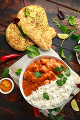 Chicken tikka masala curry with rice and naan bread