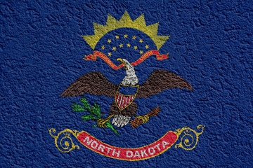 US State Politics Or Business Concept: North Dakota Flag Wall With Plaster, Background Texture